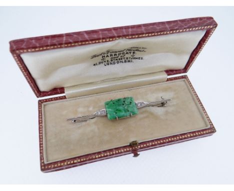 18CT WHITE GOLD JADEITE &amp; DIAMOND BAR BROOCH, the central rectangular carved jadeite tablet flanked by two diamonds eithe