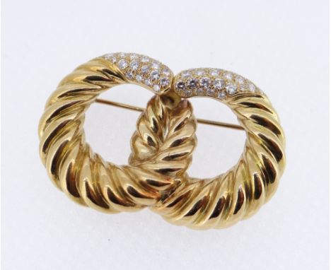 YELLOW METAL DIAMOND SET BAR BROOCH of double loop twist design, 4.4cms wide, 19.3gms, in vintage Garrard pink velvet box, im