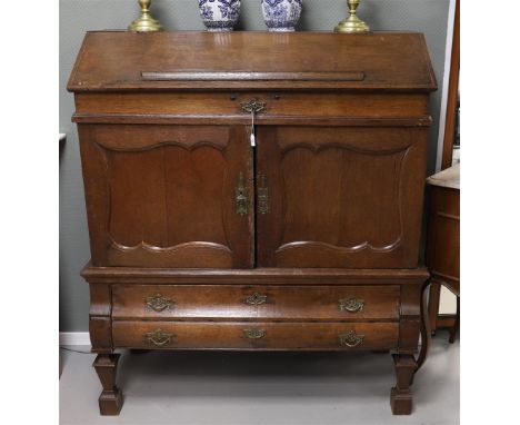 A Westerwold cabinet, so-called pulpitrum, Northern Netherlands, late 18th century. Oak wood, sloping flap behind which many 