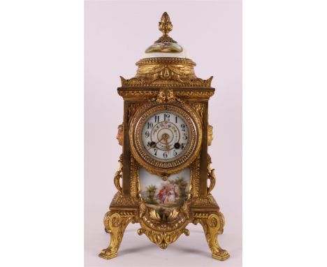 A mantel clock in a gold-plated composite metal casing with polychrome porcelain plaques and dial, among other things. with p