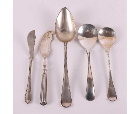 A second grade 835/1000 silver spoon with pearl edge, year letter 1911. This includes: butter knife and spoons, various year 