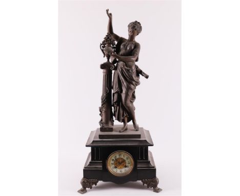 A mantel clock in black natural stone casing and white metal lady in elegant dress near a column, France, ca. 1880, h 72 cm (