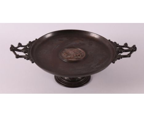 A cast iron and copper mounted tazza from 'EG Zimmermann in Hanau', 19th century. The round top inlaid with a relief panel of