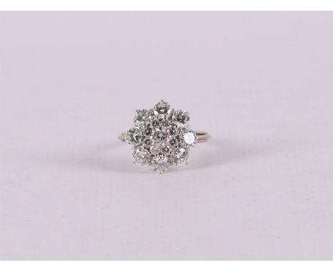 An 18 kt 750/1000 white gold entourage ring set with nine brilliant cut diamonds of approx. 0.25 crt each and an entourage of