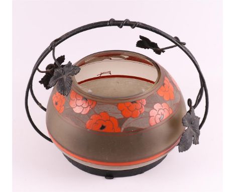 A round Art Deco fruit bowl in wrought iron frame, France, 1920-1925. Signed on the side, stylized floral orange enamel decor