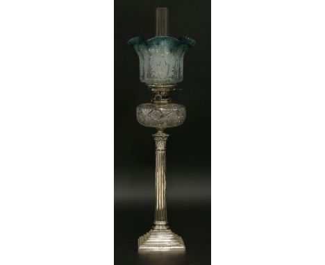 An oil lamp,with etched, blue-tinted, fluted grille shade, with Hinks' Duplex burner and cut glass reservoir on a Corinthian 