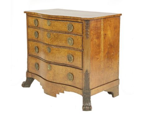 A Napoleon III burr walnut serpentine commode chest of four graduated drawers,each with gilt metal handles on scroll feet wit