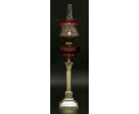 An oil lamp,with etched red and pink shade, Wright & Butler burner, faceted cranberry glass reservoir, on a silver-plated Cor