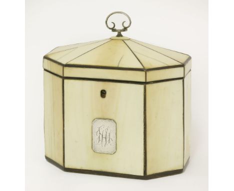 A George III ivory tea caddy,of octagonal form, the panelled lid with a scrolling silver handle, the front inset with a silve