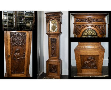 Arts &amp; Crafts Oak Cased Long Case Clock, silver chapter dial with gilt spandrels, the oak cased frame and hood carved thr