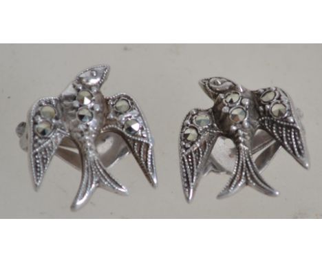 A fantastic pair of silver and marcasite Art Deco clips in the form of swallows in flight being marked silver to the verso. M