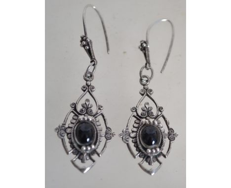 A pair of early 20th century Art Deco style silver drop pierced earrings with onyx cabochons. Marked 800 silver to verso. Mea
