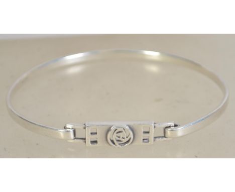 A silver 925 bangle bracelet of oval form having a hidden clasp and Celtic knot symbol to front. weighs 9.5 grams and measure
