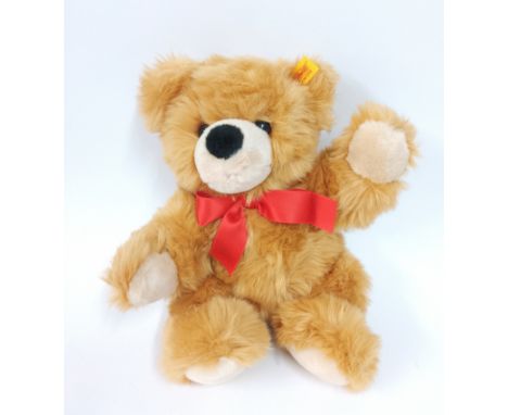 A Steiff teddy bear with red bow tie with Steiff paper bag.
