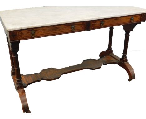 A Victorian pitch pine gothic style wash stand, with a white marble top above two frieze drawers on turned end supports with 