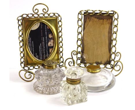 Three Victorian brass mounted inkwells, and a pair of brass chain photograph frames.
