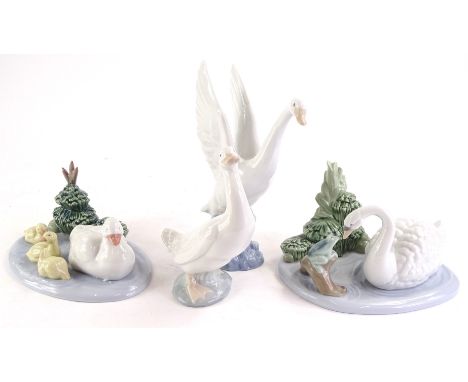 A collection of Nao porcelain figures and groups, to include a goose and goslings, swan and a frog, a goose and a swan in fli