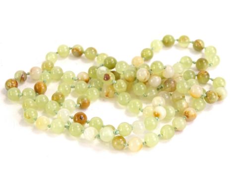 A modern jade beaded necklace, on string necklace, separated with knots, with one loose bead and clasp, 73.7g all in.