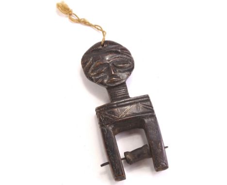 Tribal art, an African carved wooden heddle pulley, possibly Baule, 15.5cm H, 5.5cm W.