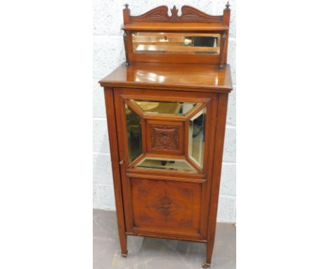 An Edwardian walnut music cabinet, the raised back with a bevelled mirror plate, the base with a single drawer with mirror ab