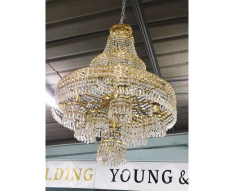 A fourteen light gilt metal chandelier, with Swarovski style cut glass drops, 66cm wide