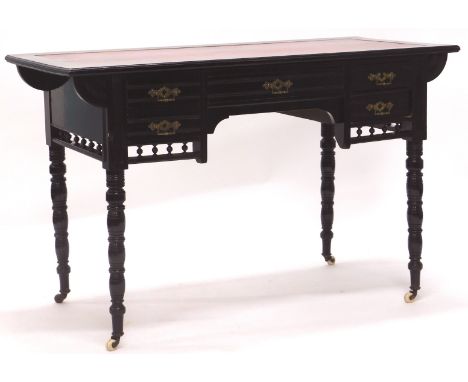 A Victorian aesthetic movement ebonised writing table, the rectangular top with a moulded edge and a later red leather insert