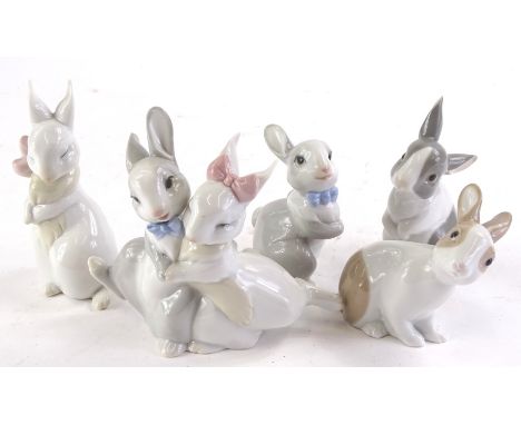 A collection of Nao rabbits, to include an embracing couple.
