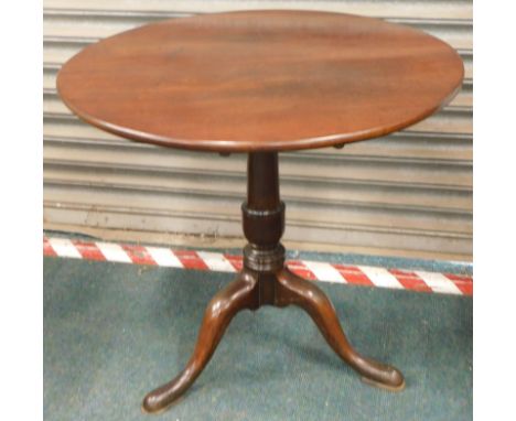 A George III mahogany table, the circular top on a turned column, on a tripod base, 77cm.