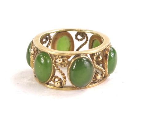 A jade set dress ring, with oval cut jade stones, and 'S' shaped mount in yellow metal, marked 14k, 5g all in, boxed.