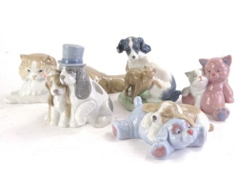 A collection of Nao porcelain animals, to include dogs and cats in various poses.