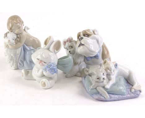 Four Nao porcelain figure groups, to include a bulldog and a poodle, two cats lying on a bed, comical rabbit and a putto with