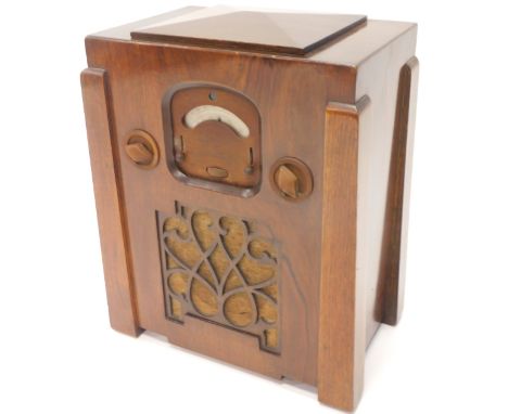 An Art Deco walnut and Bakelite valve radio, indistinctly stamped McMichael, 50cm high.