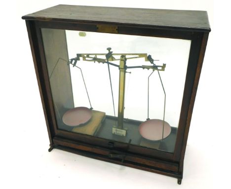 A set of S Parsons and Co of Bradford laboratory scales, in a glazed case, 41cm wide.