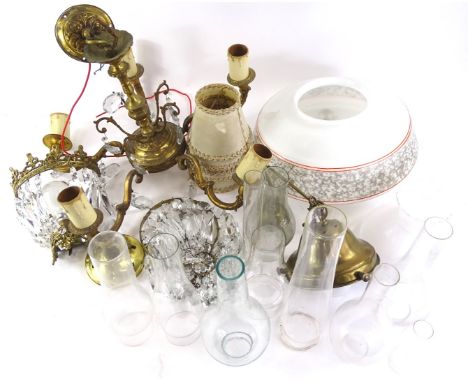A collection of clear glass oil lamp chimneys, a five branch chandelier, a wall light with cut glass drops etc.