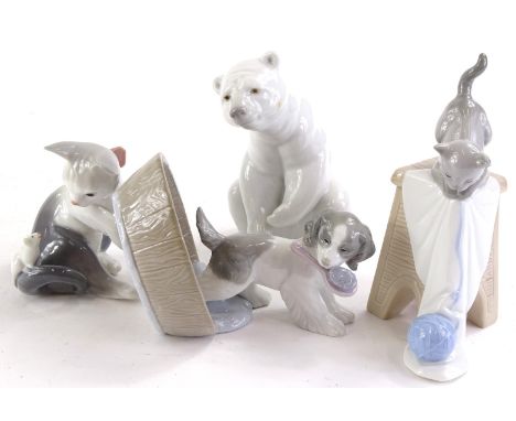 A collection of Lladro and Nao figures to include a polar bear, cat with a ball of wool etc.