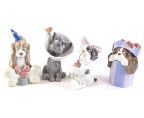 Four Nao dogs, in various poses to include a dog with a bottle of milk, one with medical cone, happy birthday bone etc.