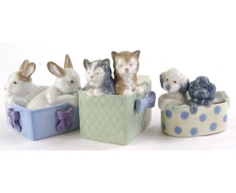 Pairs of Nao porcelain animals, cats dogs and rabbits.