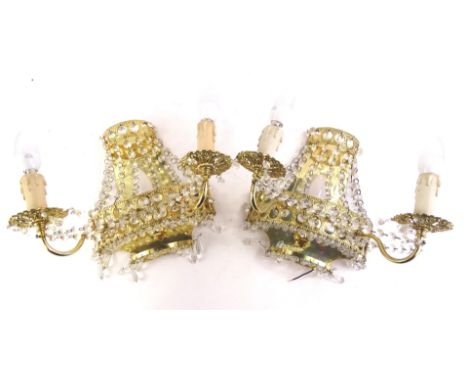A pair of gilt metal two branch wall lights, with Swarovski light cut crystal drops and a basket type fitting, possibly incom