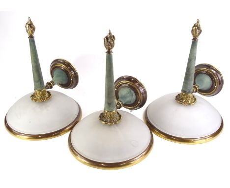Three Art Deco style bronzed metal wall lights, each with a domed frosted shade, 45cm high. 