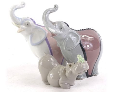 A pair of comical Nao porcelain elephants, each with a coloured blanket and a hippo and frog figure, 2 boxes.