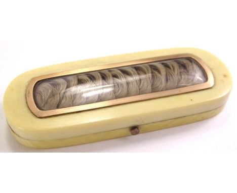 A 19thC ivory toothpick or patch box, the rectangular hinged lid with a yellow metal boarder enclosing a plated lock of hair,