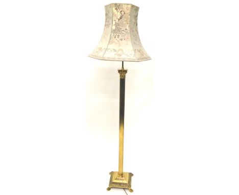 A brass Corinthian column standard lamp, with a patterned fabric shade, on square base with paw feet, 178cm high.