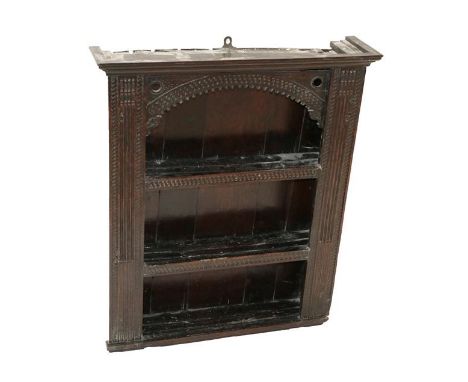 ~ A 17th Century Joined Oak Boarded Glass Case, the moulded top above guilloche patterned carved shelves, all between stop-fl