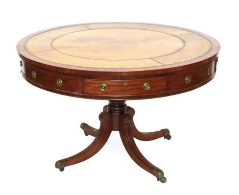 A Late George III Mahogany Drum Table, early 19th century, with later brown and gilt tooled leather top above four real and f