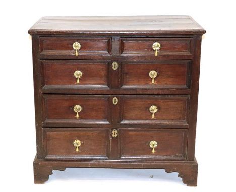 A Late 17th Century Joined Oak Chest, the moulded top above two short drawers with three two-as-one moulded drawers below, on