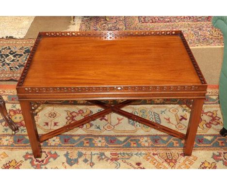 A Reproduction Mahogany Rectangular Coffee Table, in Chippendale style, with pierced fretwork gallery, on square form legs wi