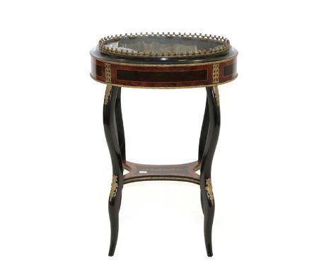 A Late 19th Century Louis XVI Style Ebonised, Amboyna and Gilt Metal Mounted Jardiniere Table, of oval form, on slender cabri