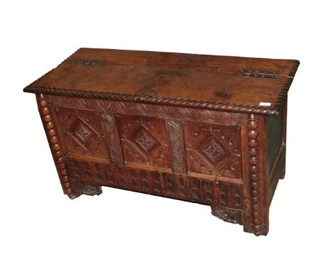A Late 17th Century Joined Oak Chest, the hinged lid with iron H shaped riveted hinges, the carved frieze with three lozenge 