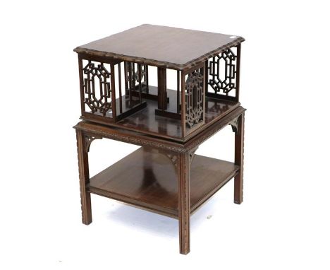An Early 20th Century Chippendale Revival Mahogany and Fret Carved Revolving Bookcase, the moulded top above a divided interi