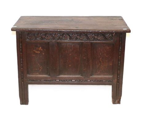 An Early 18th Century Joined Oak Chest, the hinged lid enclosing a vacant interior above a scrolled frieze with three moulded